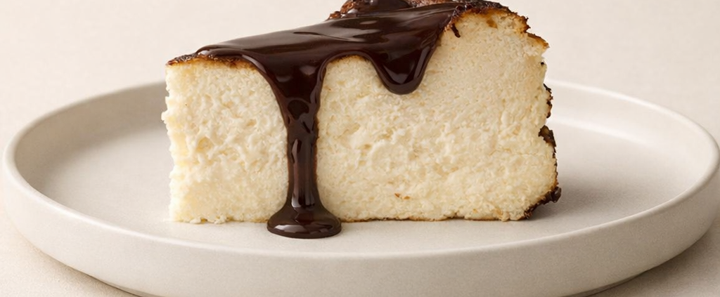 Slice of cheesecake with chocolate drizzle