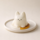 Cute cat-shaped ceramic ornament on plate