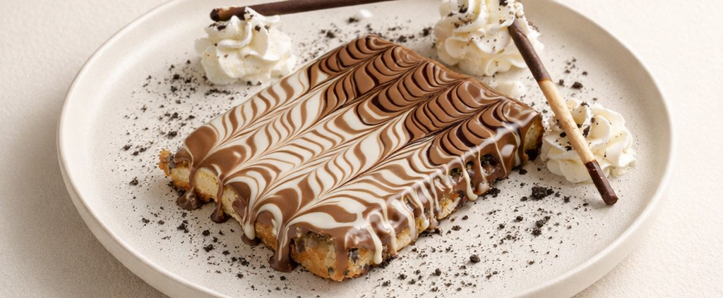Chocolate swirled dessert with cream and sticks